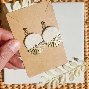 Handmade white polymer clay earrings with gold charm.